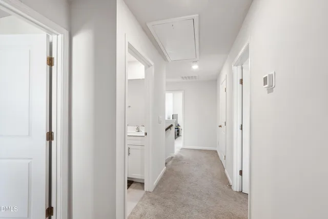 a view of a hallway with wooden shelves