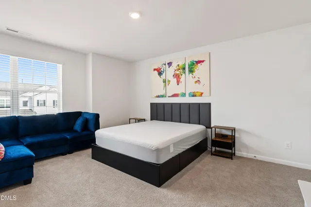 a bedroom with a bed and a couch