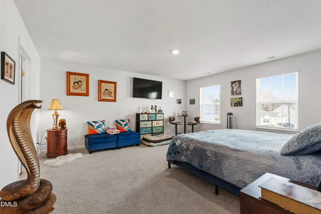 a bedroom with bed and a large window