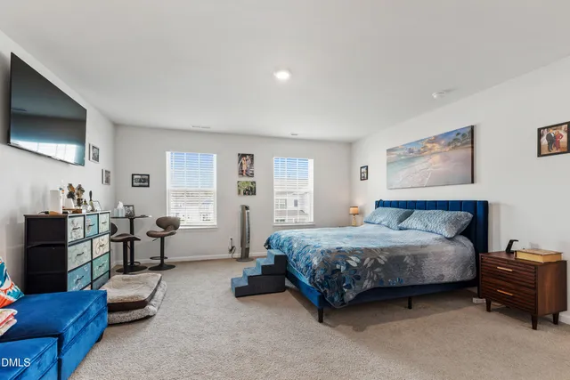 a spacious bedroom with a bed and furniture