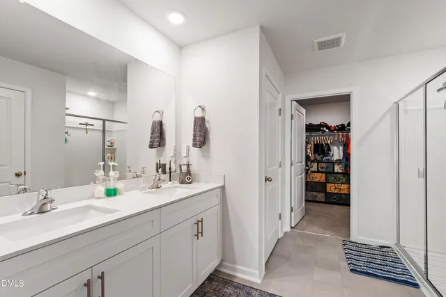 a bathroom with a double vanity sink and a mirror