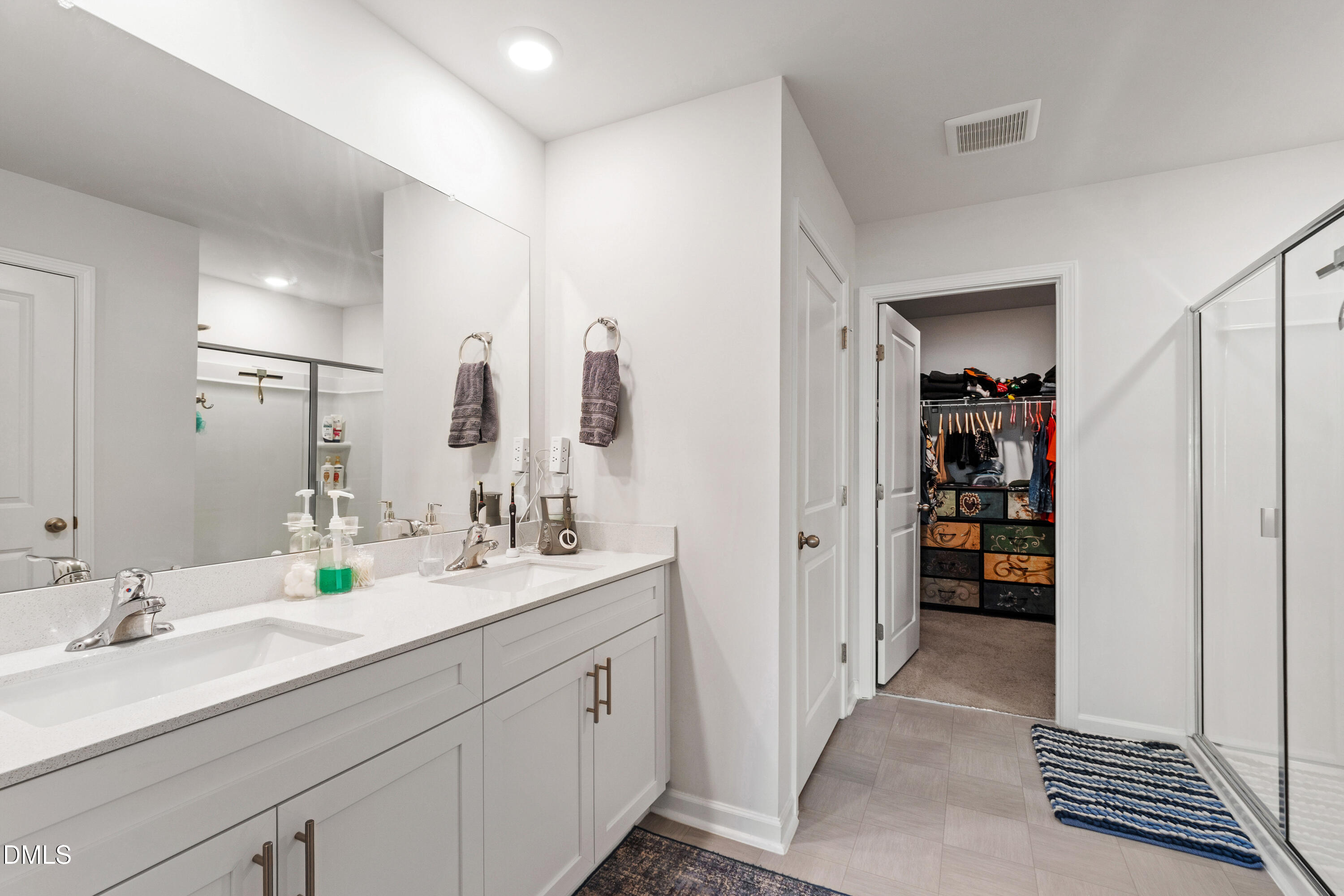 2128 Fletchers Ridge Drive Durham, NC 27703 - Photo 32 of 38 a bathroom with a double vanity sink and a mirror