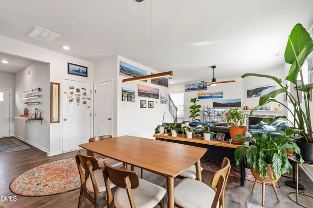a view of a dining room with furniture and wooden floor