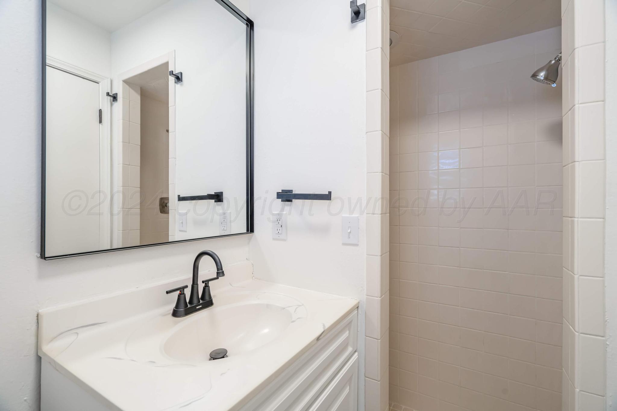 3206 Wind Song Drive Amarillo, TX 79103 - Photo 16 of 27 a bathroom with a sink and a mirror