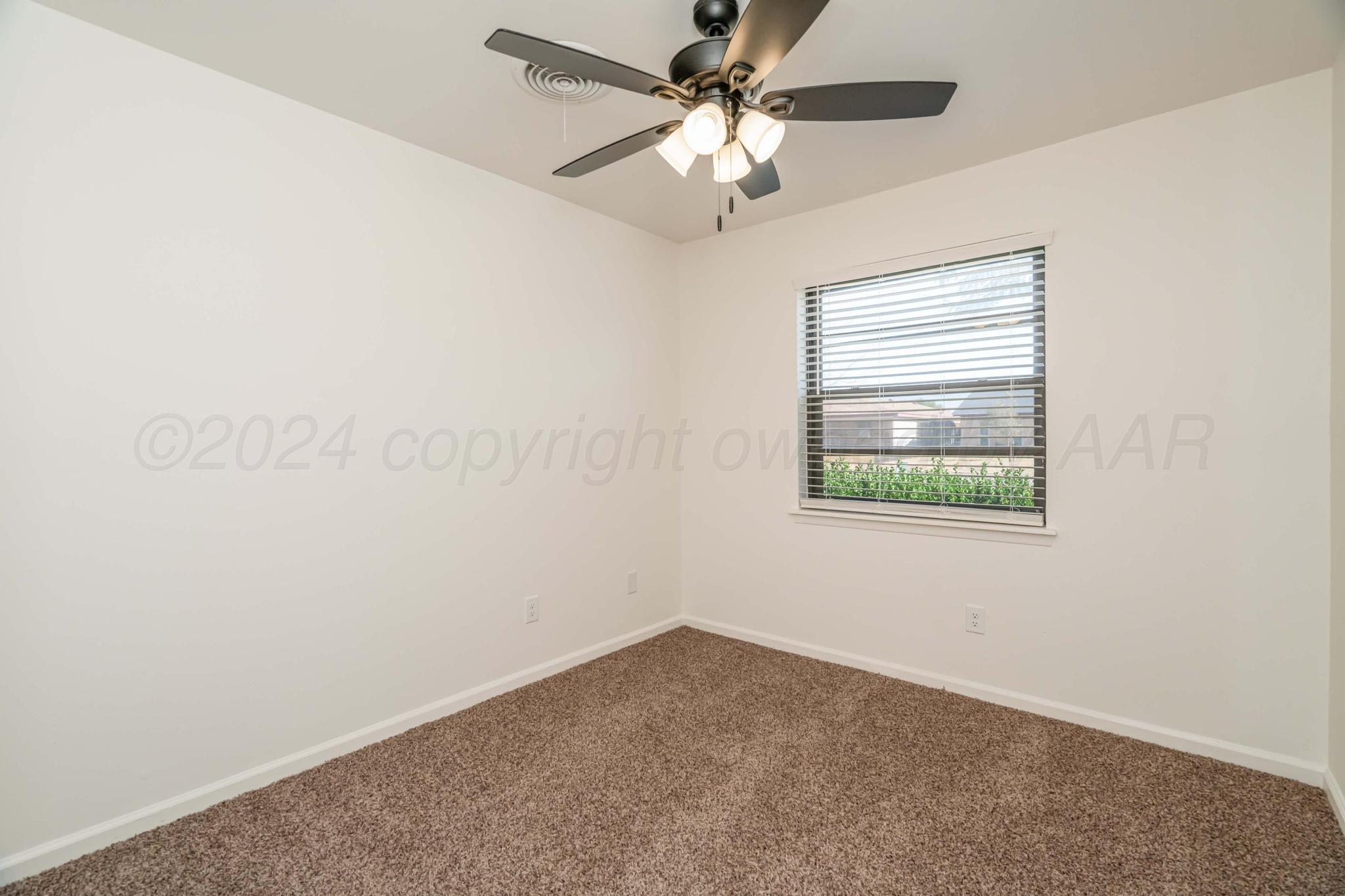 3206 Wind Song Drive Amarillo, TX 79103 - Photo 17 of 27 an empty room with a window and a fan