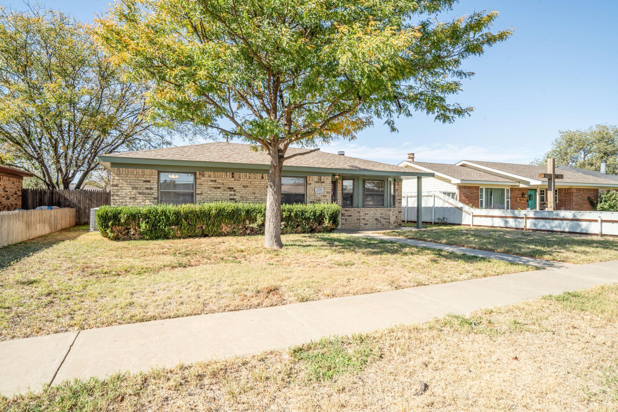 3206 Wind Song Drive Amarillo, TX 79103 - Photo 2 of 27 a house with a tree in front of it