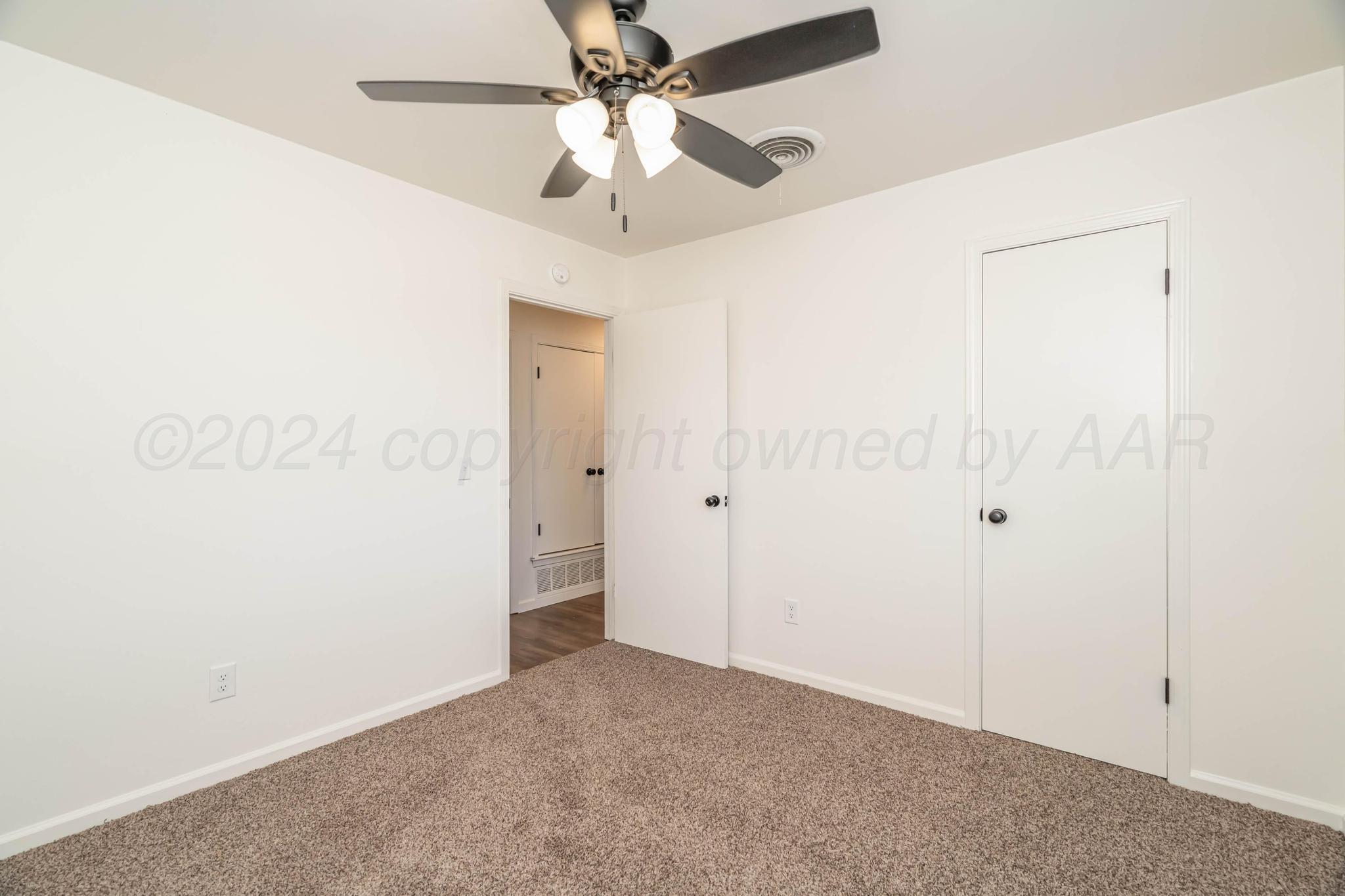 3206 Wind Song Drive Amarillo, TX 79103 - Photo 22 of 27 an empty room with a ceiling fan and a window