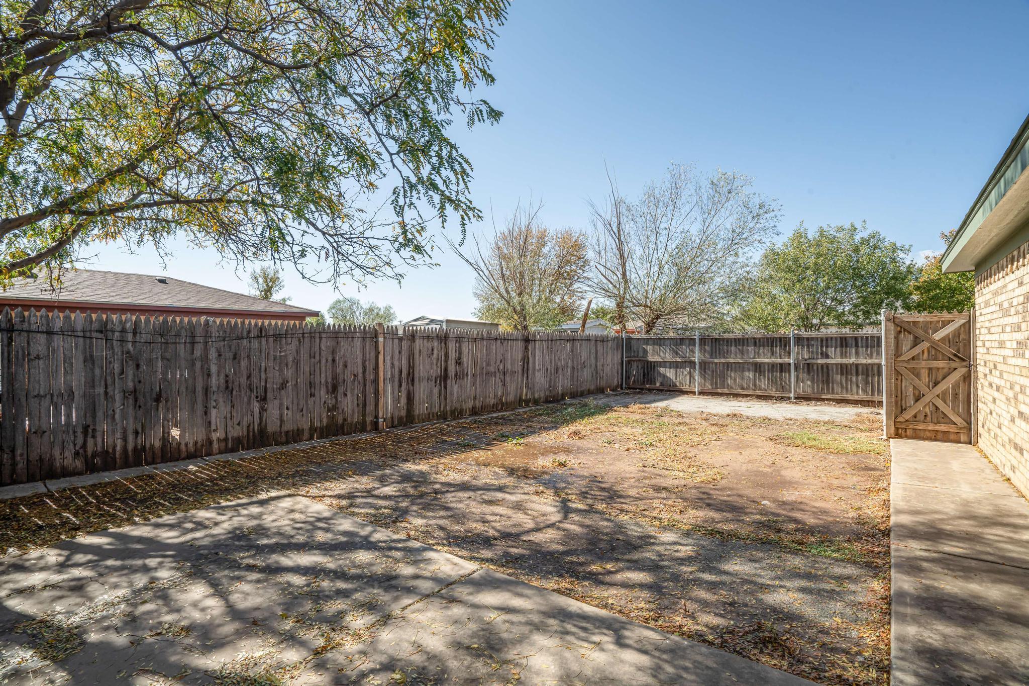 3206 Wind Song Drive Amarillo, TX 79103 - Photo 23 of 27 a view of backyard with wooden fence