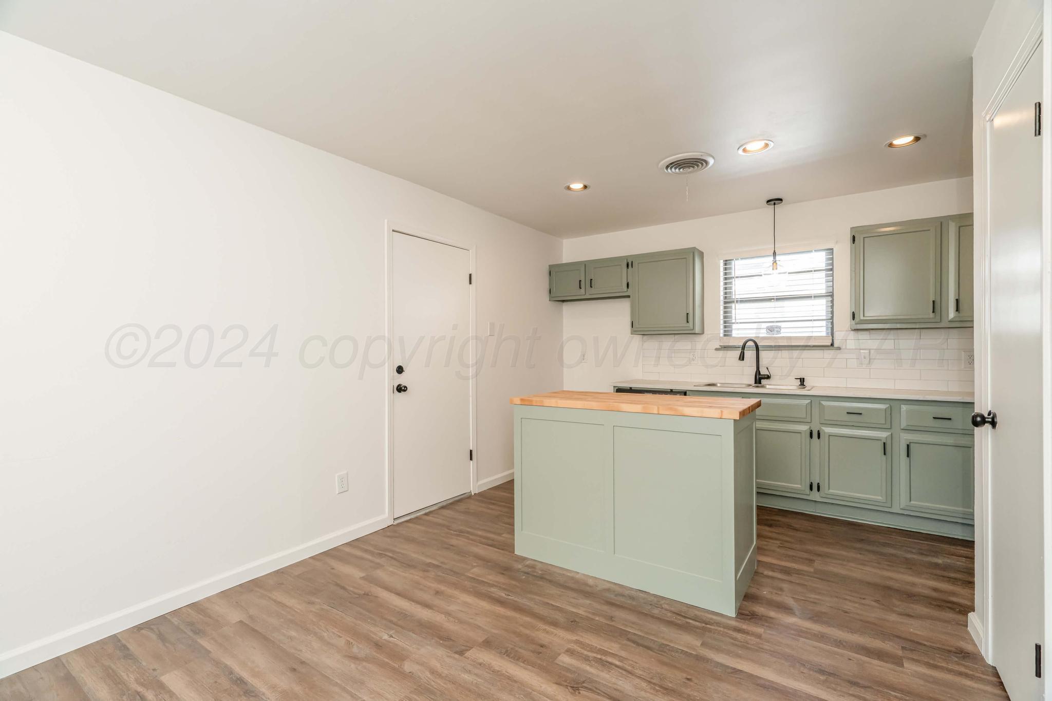 3206 Wind Song Drive Amarillo, TX 79103 - Photo 6 of 27 a kitchen with a sink cabinets stainless steel appliances and a window