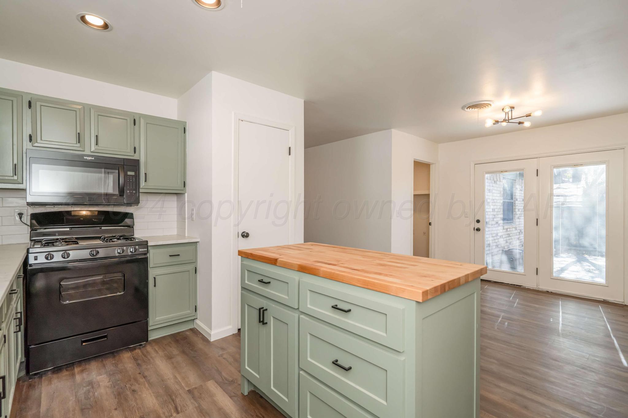 3206 Wind Song Drive Amarillo, TX 79103 - Photo 10 of 27 a kitchen with a stove and a refrigerator