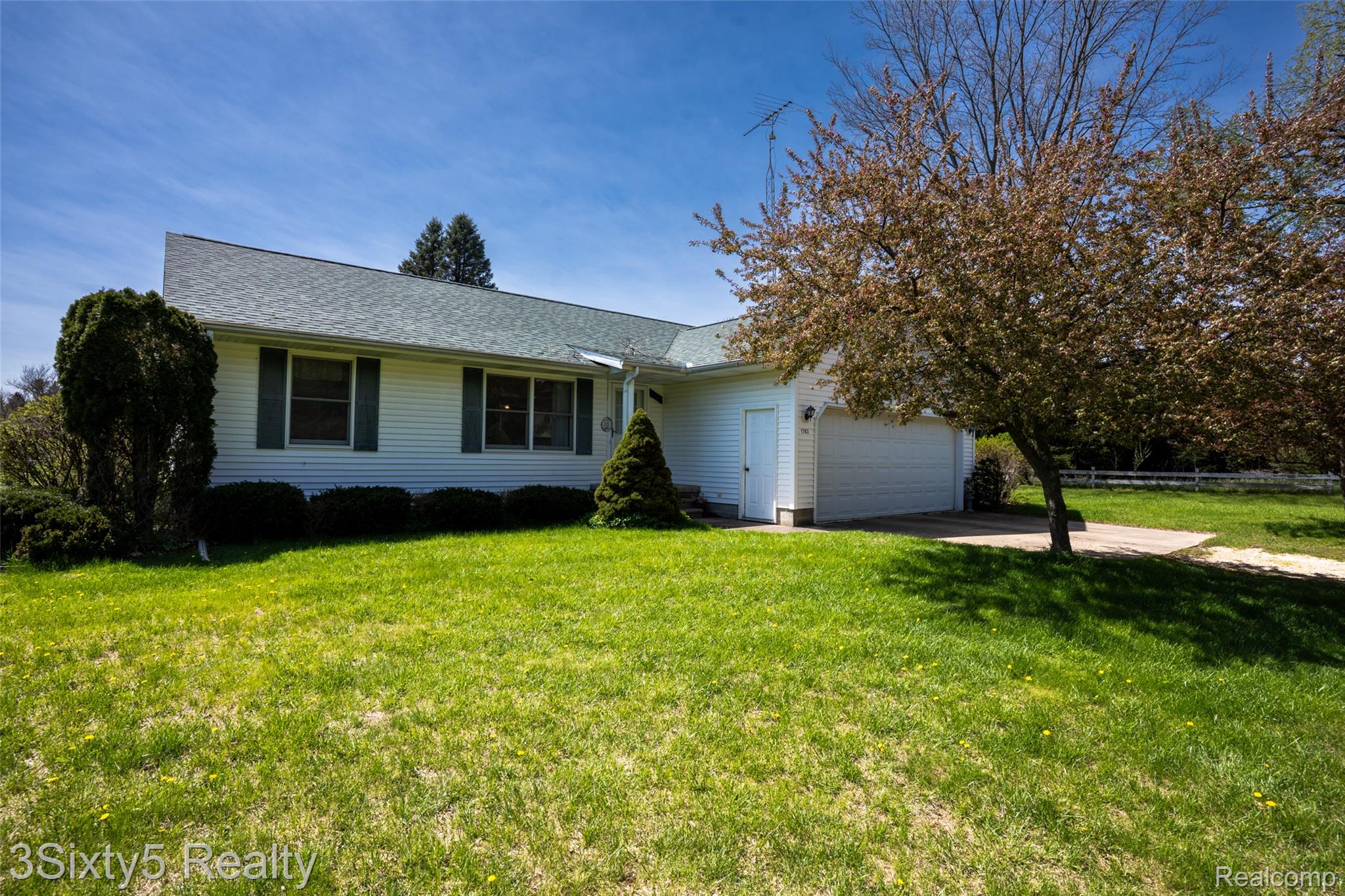 1783 Farnsworth Road Lapeer, MI 48446 - Photo 2 of 51 View of front of property with a front yard, concrete driveway, and an attached garage