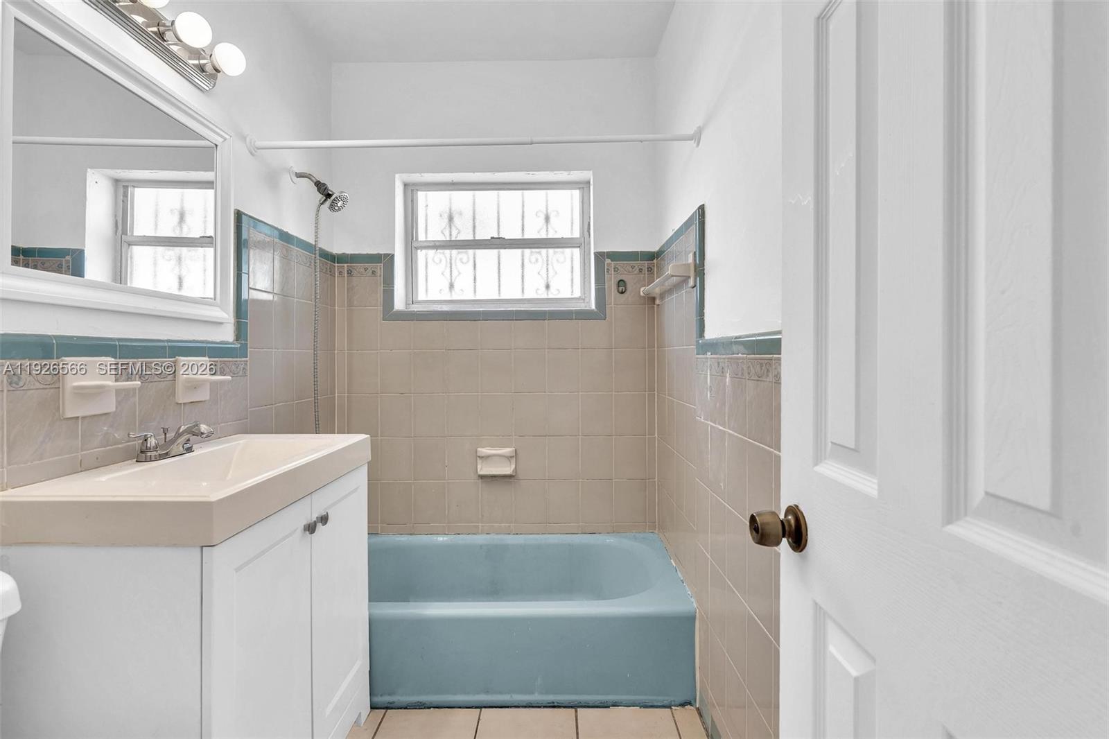 2839 Southwest 24th Street, Unit 2 Miami, FL 33145 - Photo 13 of 15 a bathroom with a tub sink and mirror
