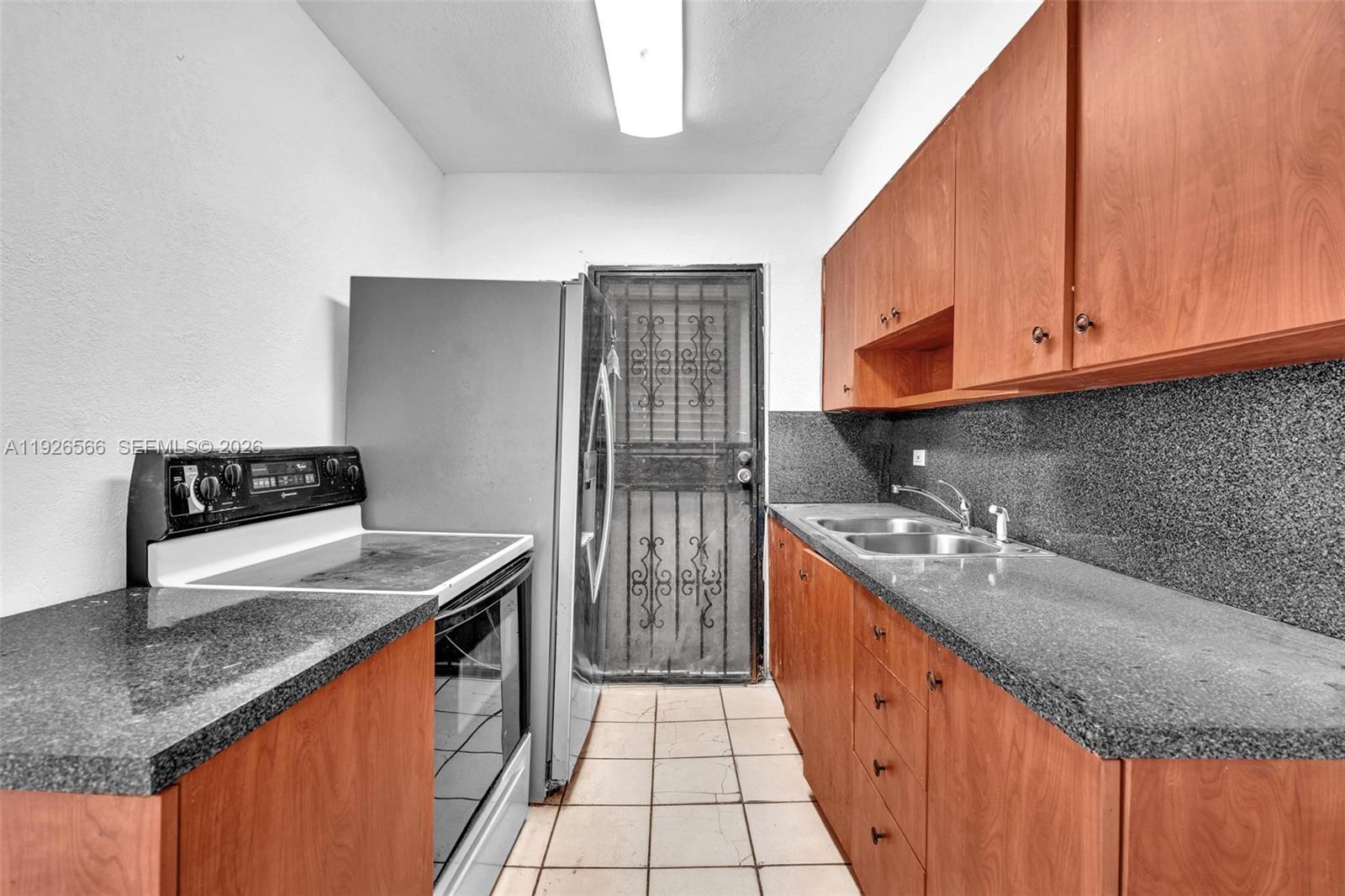 2839 Southwest 24th Street, Unit 2 Miami, FL 33145 - Photo 7 of 15 a kitchen with stainless steel appliances granite countertop a sink stove and refrigerator