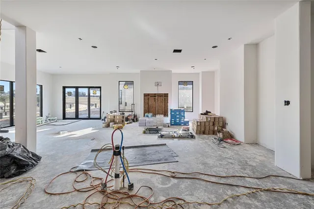 a living room with furniture a rug and white walls