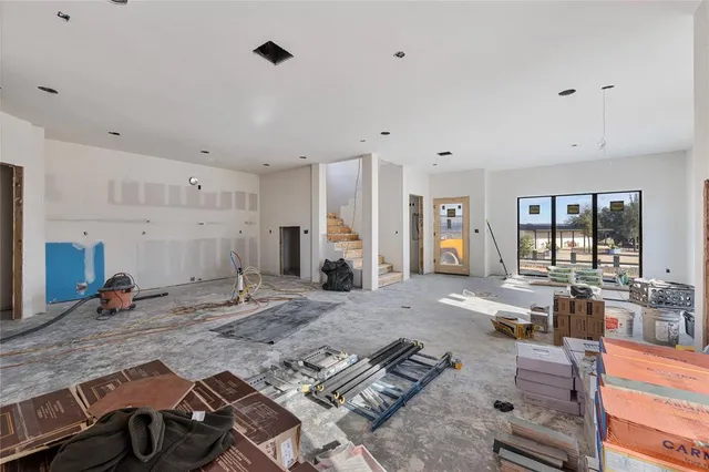 a living room with furniture stove and wooden floor
