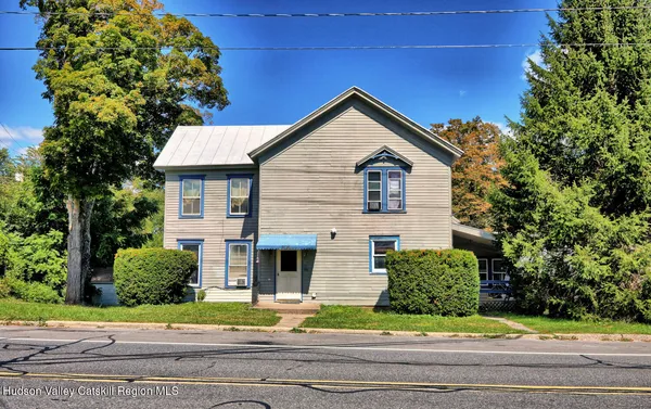 a front view of a house with a garden