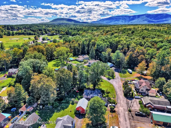 a living room with furniture a mirror and a window