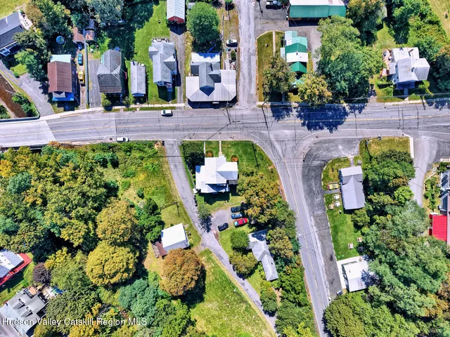 a kitchen with granite countertop a refrigerator stove top oven and sink