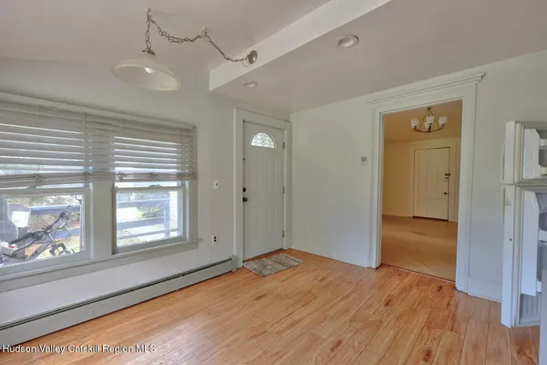 an empty room with wooden floor and closet