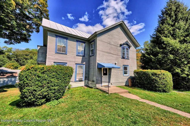 a front view of a house with a yard