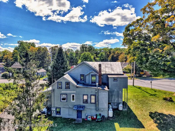 an aerial view of a house roof deck with chairs and flower plants