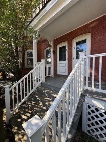 a view of a house with wooden deck
