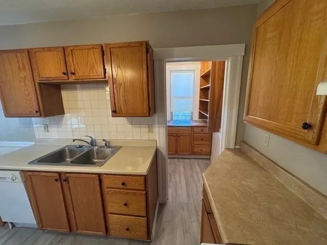 a kitchen with sink cabinets and window