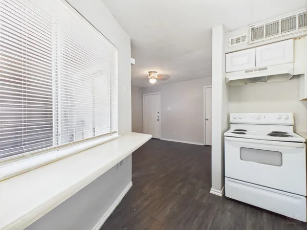 a view of washer and dryer with kitchen in the background