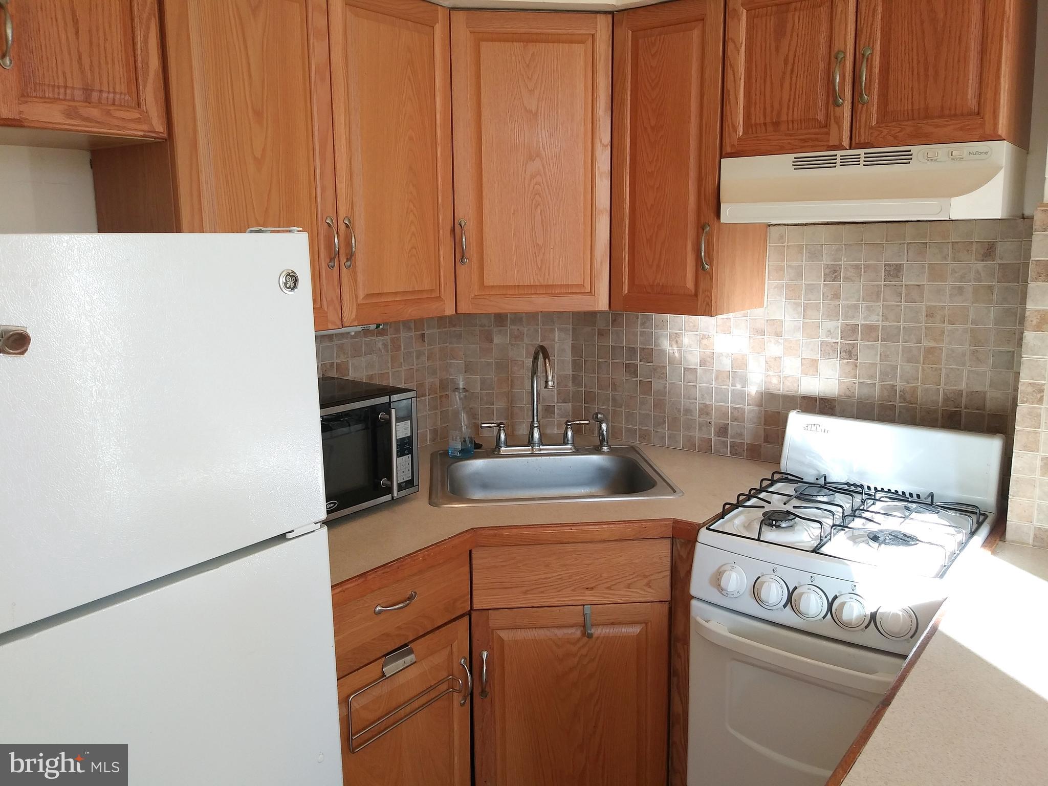 715 South 23rd Street, Unit 1F Philadelphia, PA 19146 - Photo 3 of 12 a kitchen with appliances a sink and a cabinets