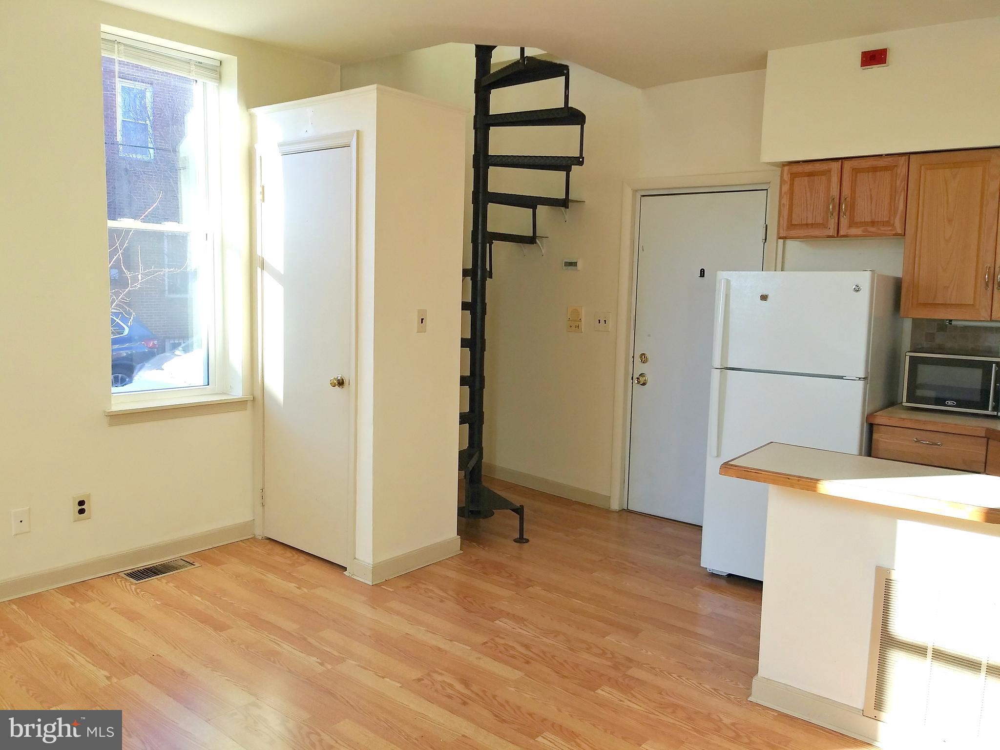 715 South 23rd Street, Unit 1F Philadelphia, PA 19146 - Photo 4 of 12 a kitchen with stainless steel appliances a refrigerator and a stove top oven