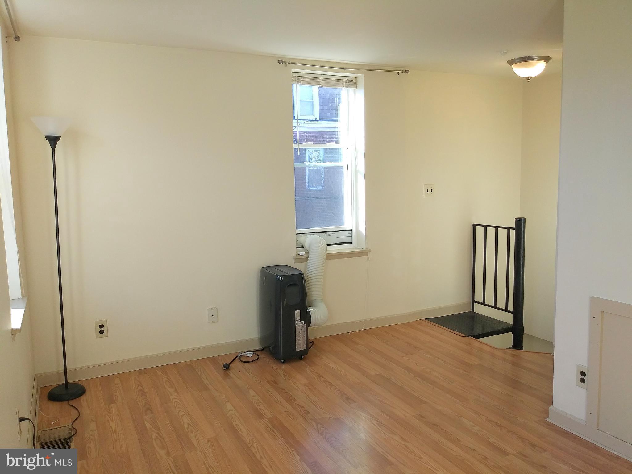 715 South 23rd Street, Unit 1F Philadelphia, PA 19146 - Photo 7 of 12 a view of empty room with wooden floor and fan