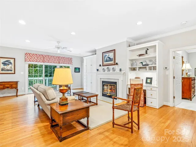 a living room with furniture a fireplace and next to a window