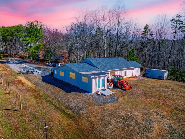a view of a house with outdoor space and sitting area