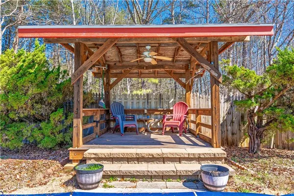 a view of a roof deck with table and chairs under an umbrella