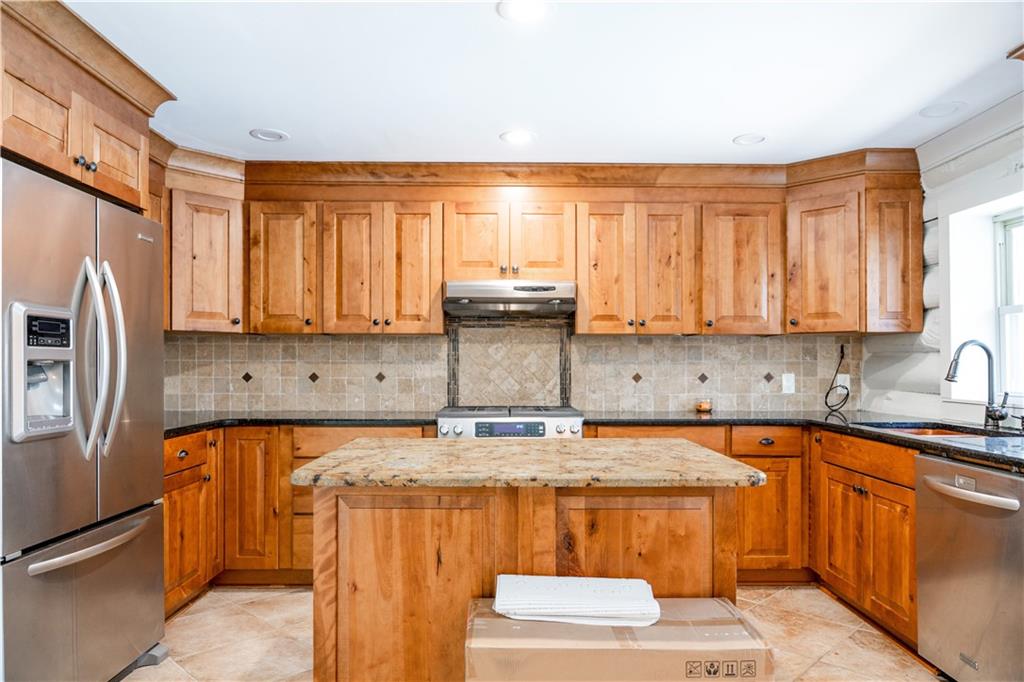 110 Rathgeb Trail Jasper, GA 30143 - Photo 43 of 62 a kitchen with stainless steel appliances granite countertop a sink stove and refrigerator