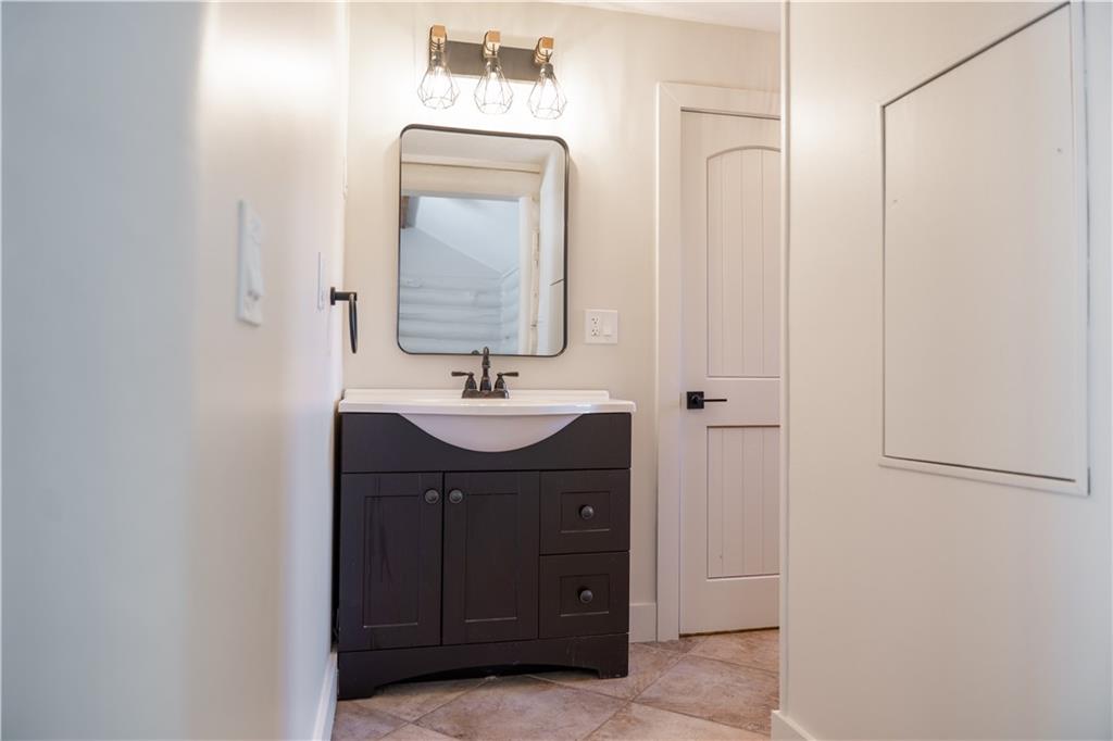 110 Rathgeb Trail Jasper, GA 30143 - Photo 45 of 62 a bathroom with a sink and a mirror