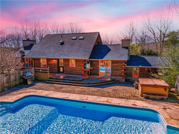 a view of a lush green hillside and a houses