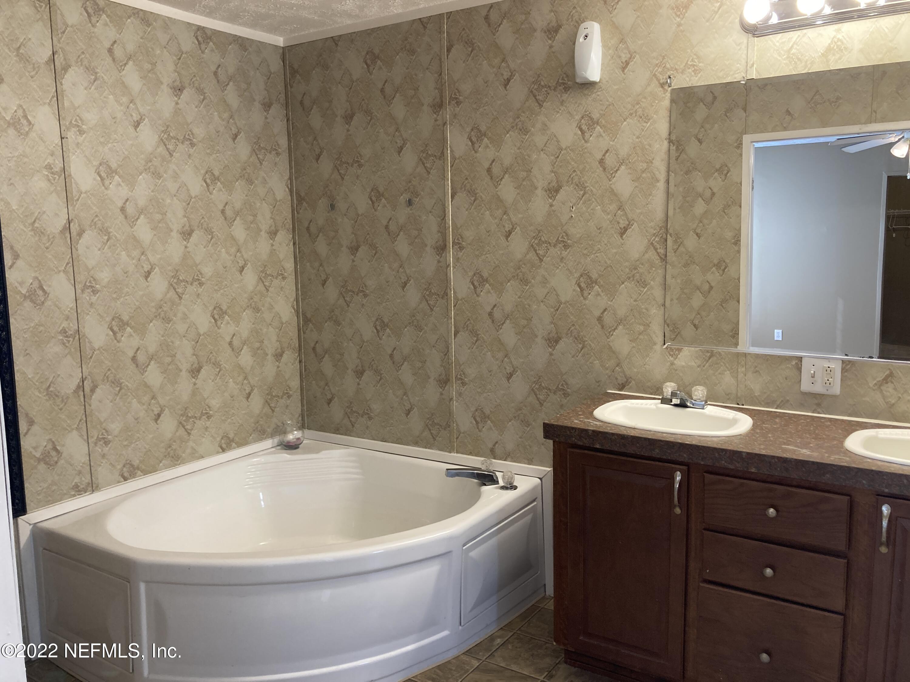1352 Long Bay Road Middleburg, FL 32068 - Photo 11 of 13 a bathroom with a bathtub and sink