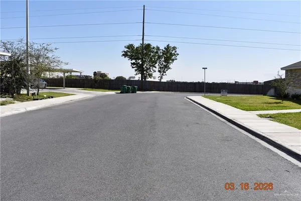 a view of a street with a building in the background