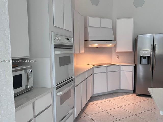 6110 Falconsgate Avenue Davie, FL 33331 - Photo 11 of 33 a kitchen with granite countertop a refrigerator and a stove top oven