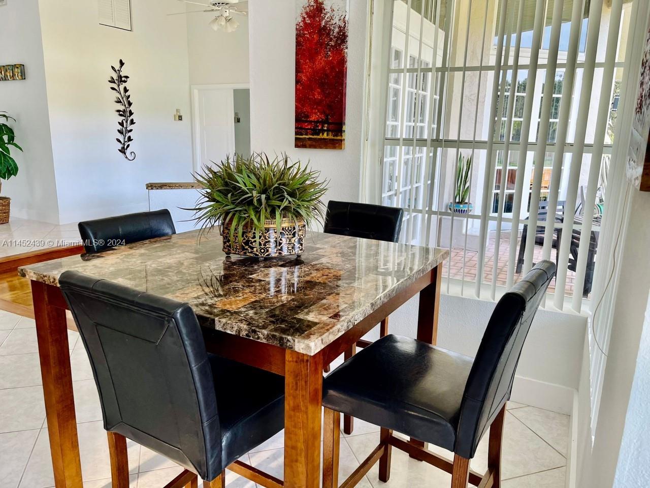 6110 Falconsgate Avenue Davie, FL 33331 - Photo 14 of 33 a view of a dining room with furniture and wooden floor