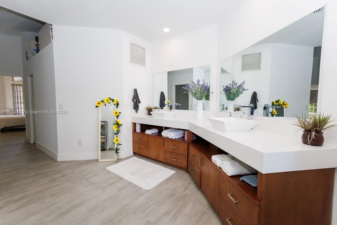 6110 Falconsgate Avenue Davie, FL 33331 - Photo 17 of 33 a kitchen with a sink a counter and chairs