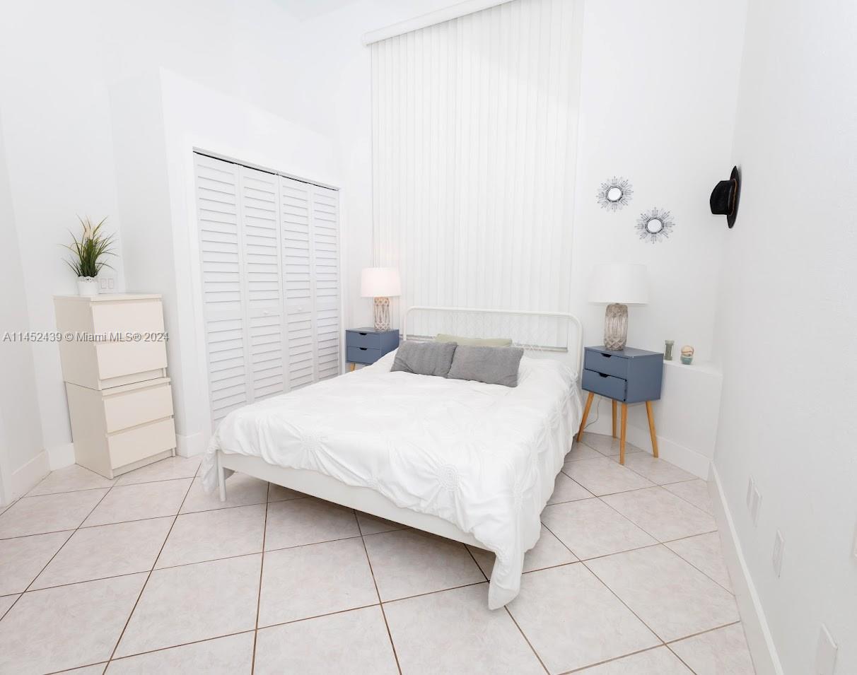 6110 Falconsgate Avenue Davie, FL 33331 - Photo 20 of 33 a bedroom with a bed and a cabinets