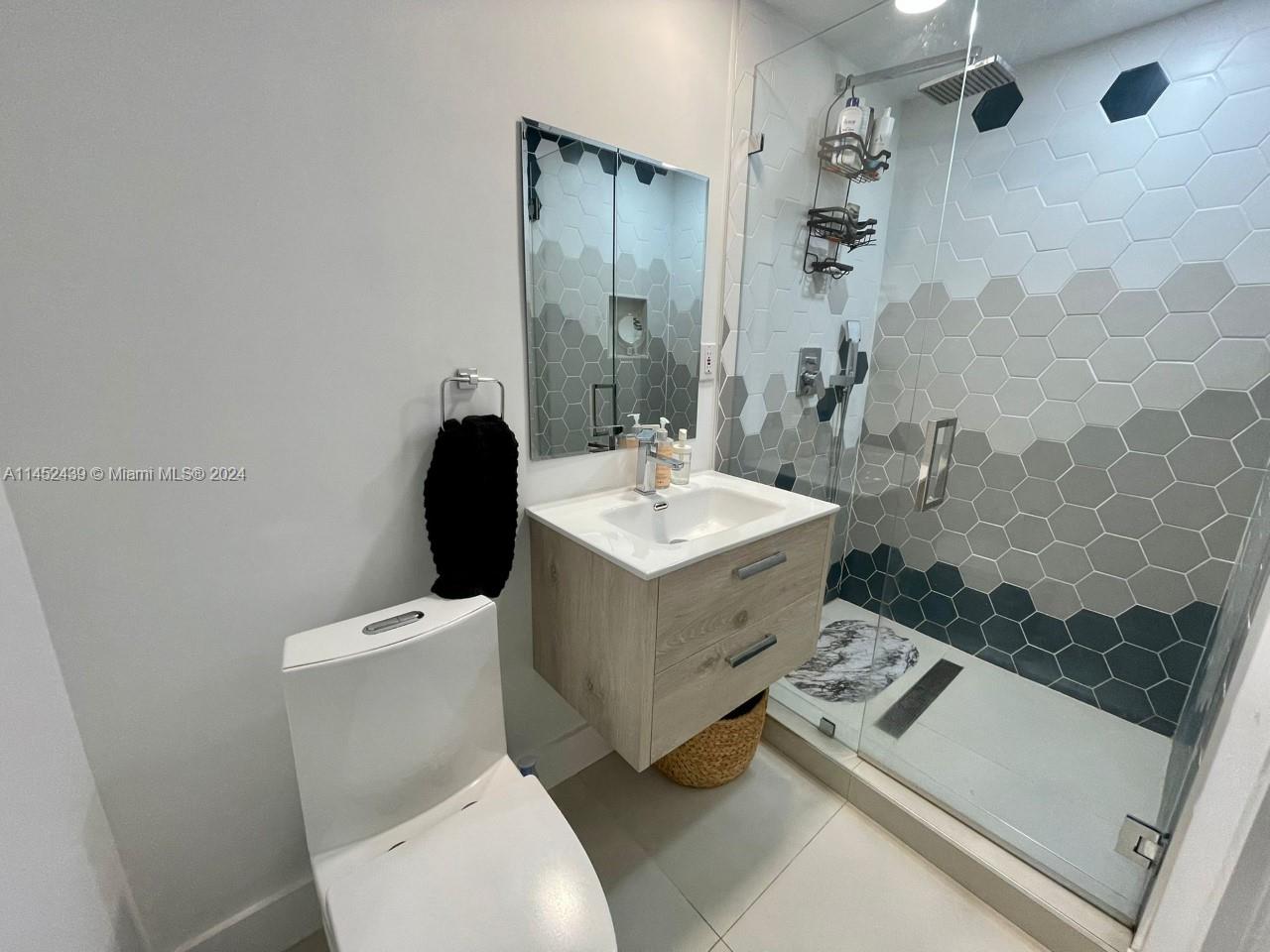 6110 Falconsgate Avenue Davie, FL 33331 - Photo 21 of 33 a bathroom with a sink toilet and shower