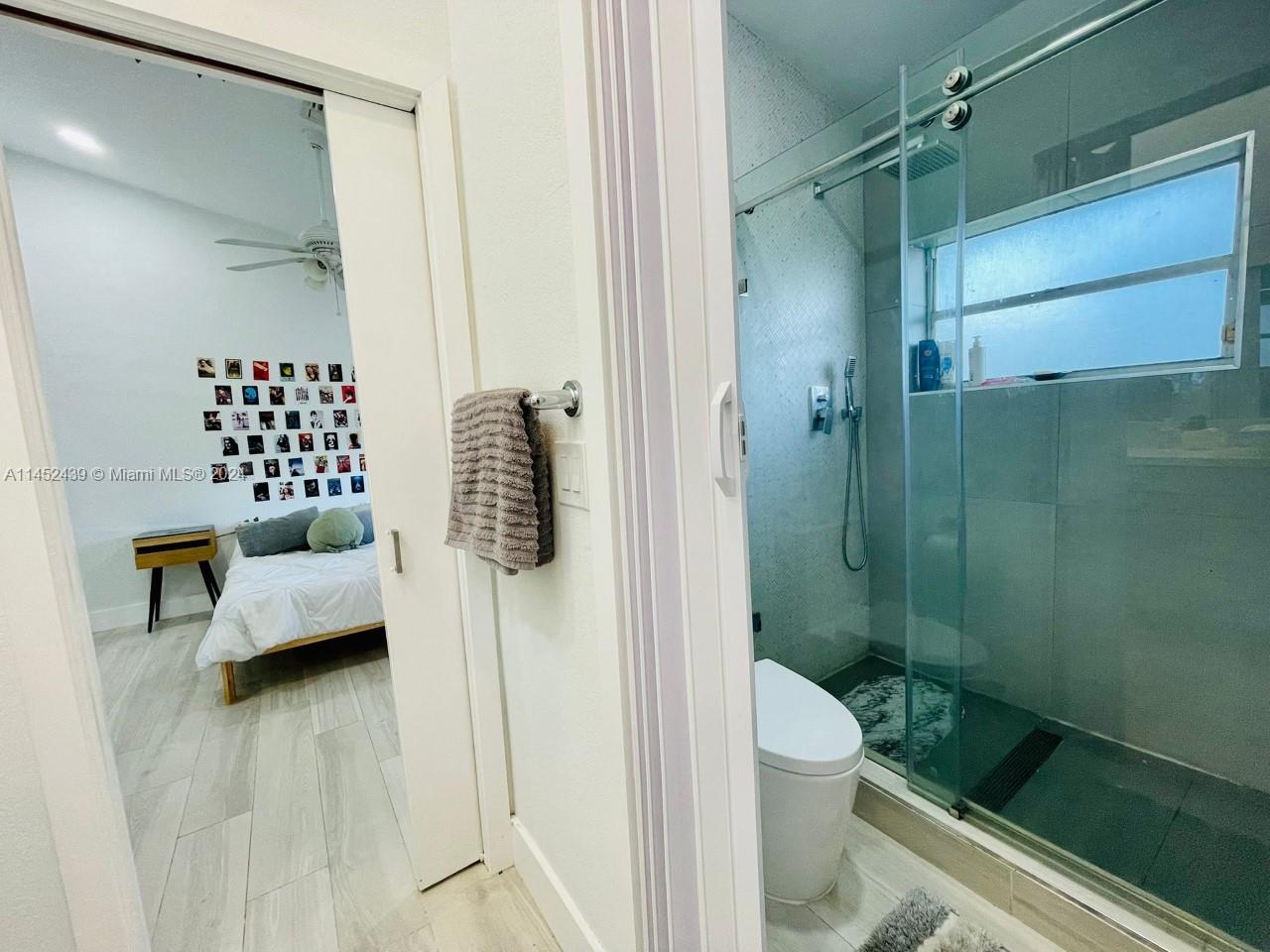 6110 Falconsgate Avenue Davie, FL 33331 - Photo 23 of 33 a bathroom with a shower a toilet and sink