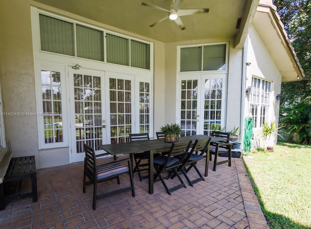 6110 Falconsgate Avenue Davie, FL 33331 - Photo 26 of 33 a view of a patio with table and chairs