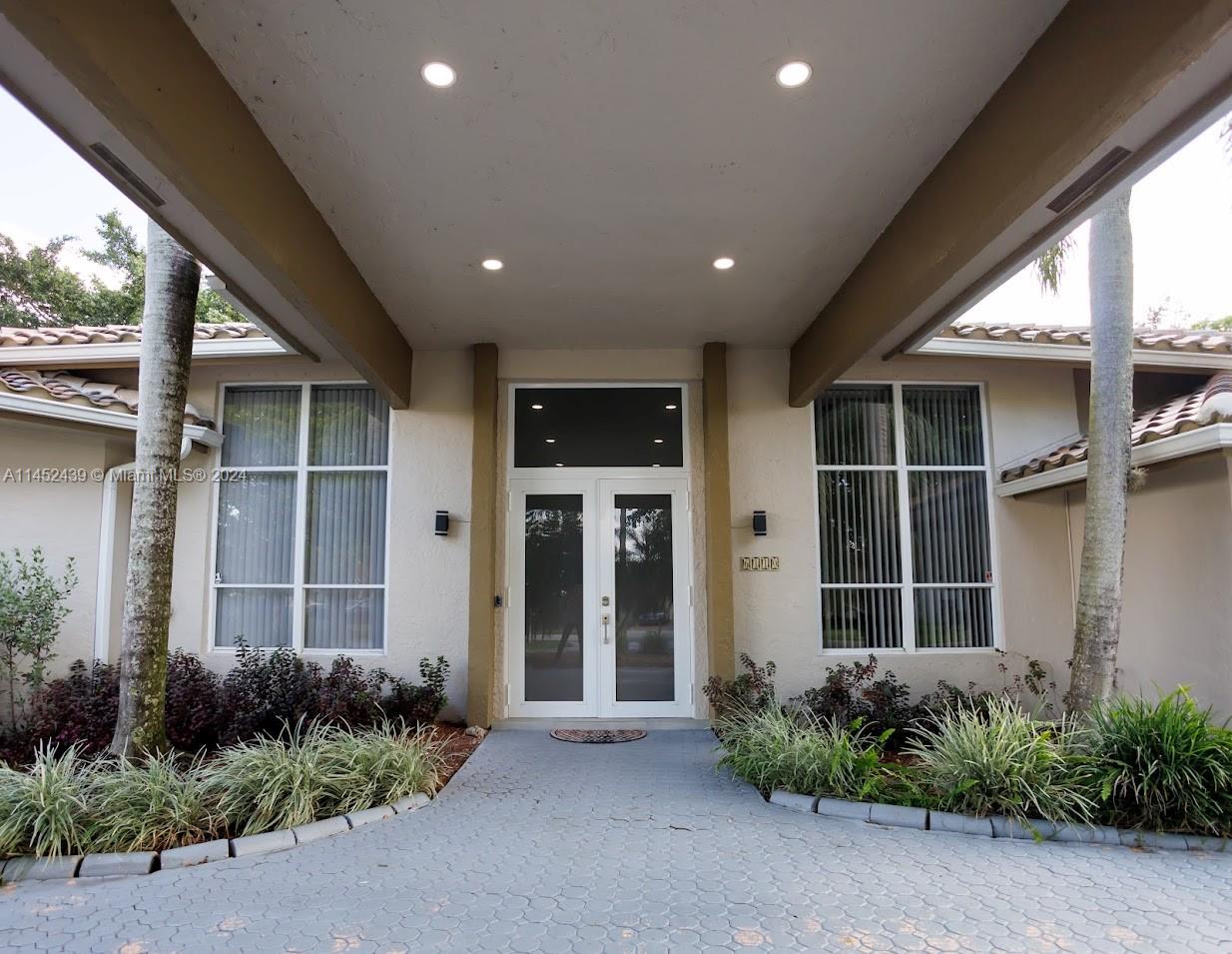 6110 Falconsgate Avenue Davie, FL 33331 - Photo 3 of 33 a view of an entryway of house with potted plants