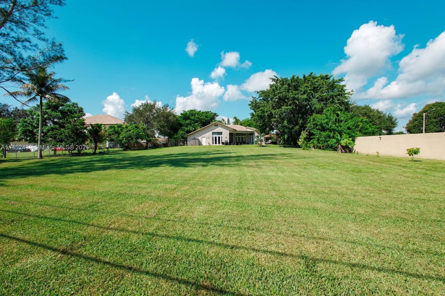 6110 Falconsgate Avenue Davie, FL 33331 - Photo 32 of 33 a view of a golf course with a house