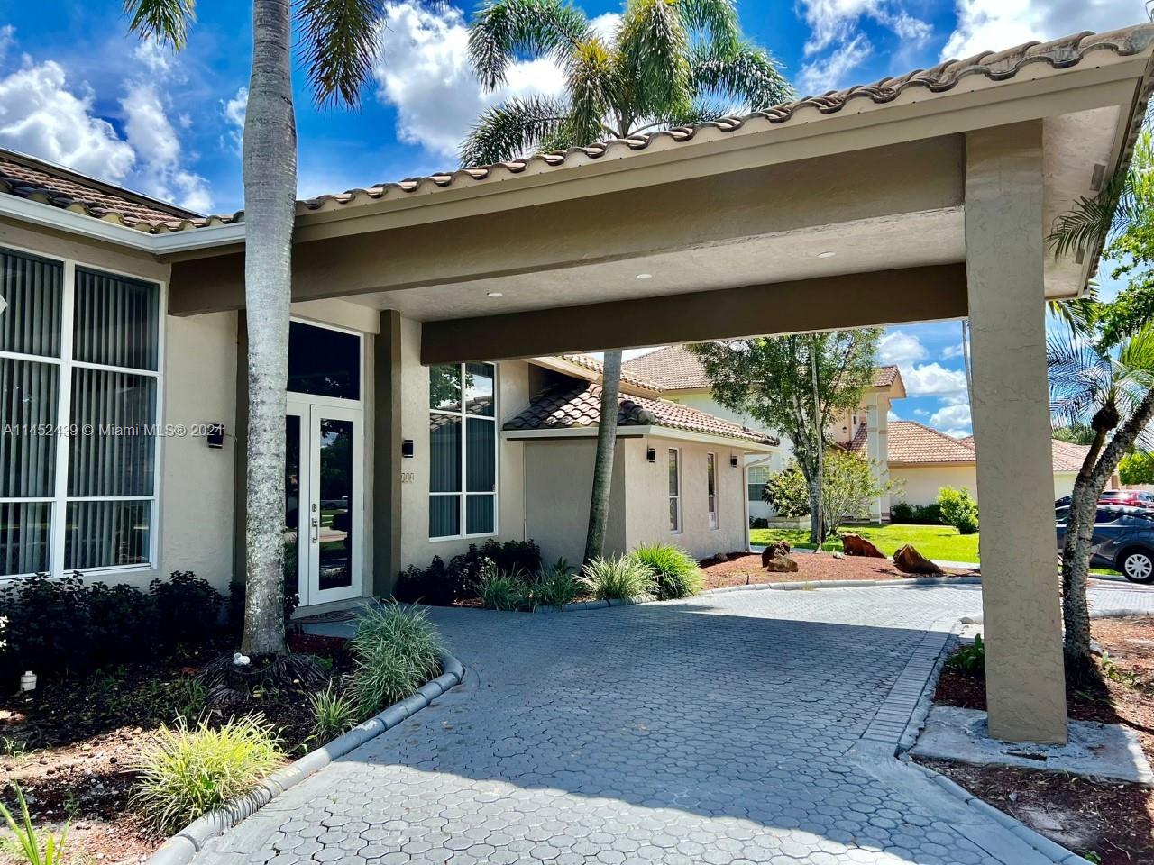 6110 Falconsgate Avenue Davie, FL 33331 - Photo 4 of 33 a front view of a house with garden