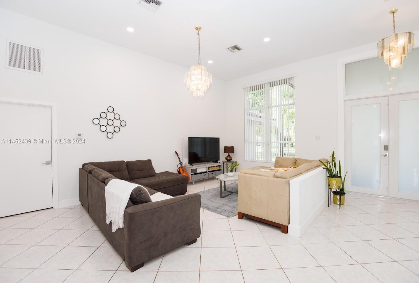 6110 Falconsgate Avenue Davie, FL 33331 - Photo 6 of 33 a living room with furniture and a flat screen tv